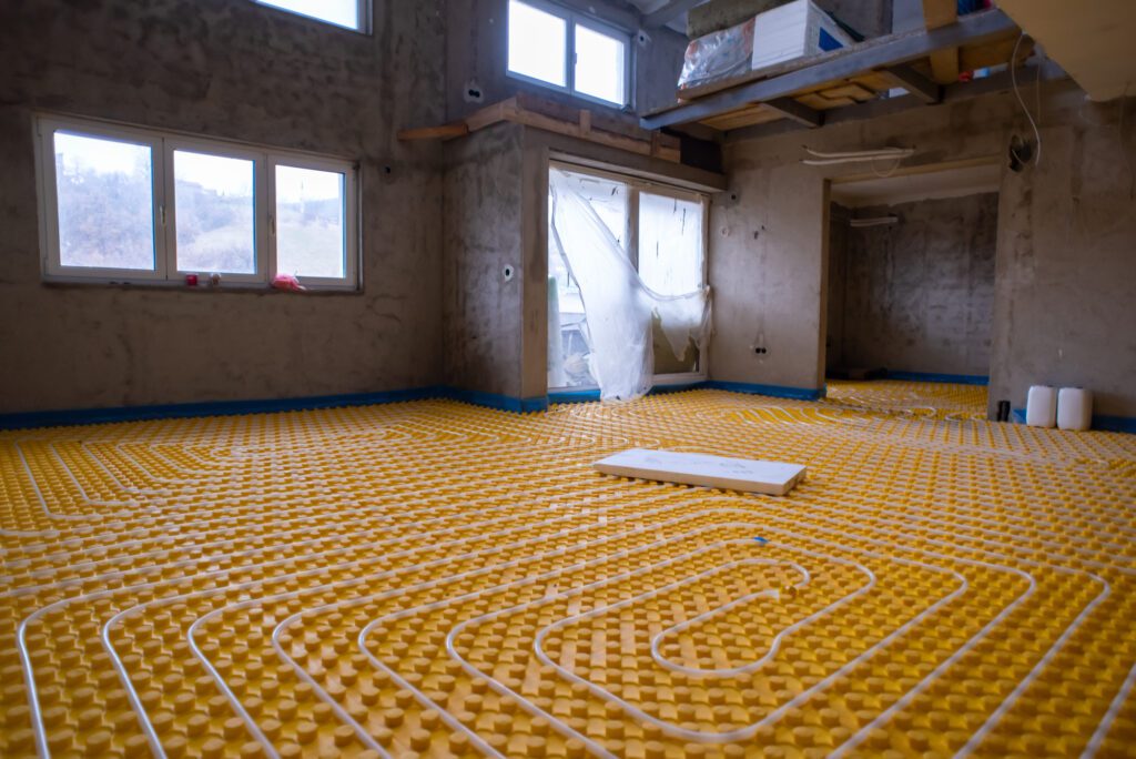 yellow underfloor heating installation with white polyethylene pipes on construction site of new two level apartment